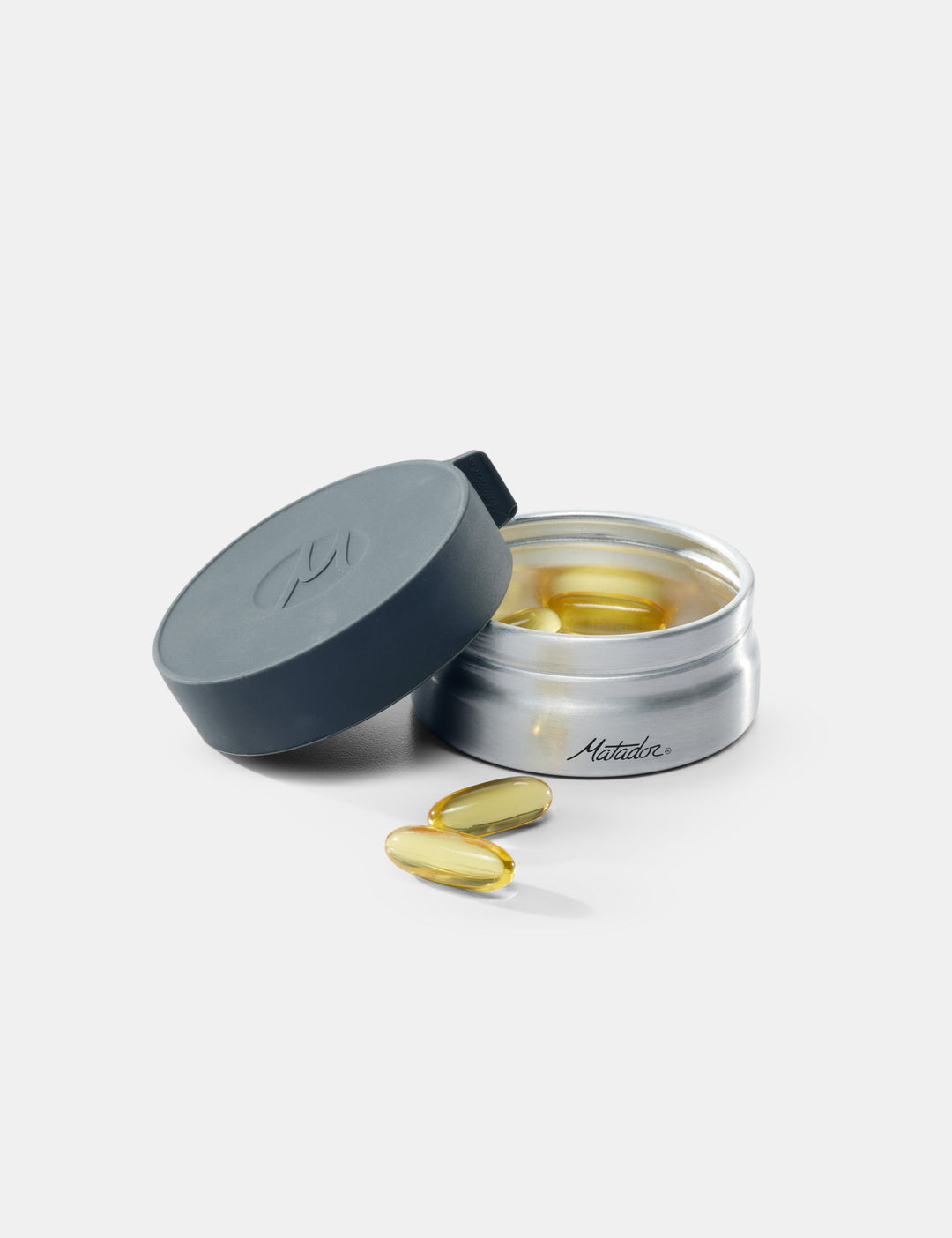 Matador Waterproof Travel Canister - 100ml - open container of supplements with pills on a white background