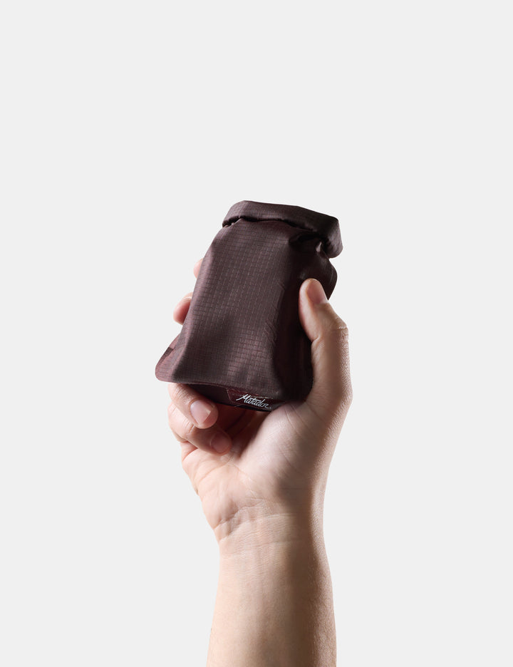 Matador FlatPak Travel Soap Bar Case (V2) in Garnet - hand holding Garnet soap bar case against a white background