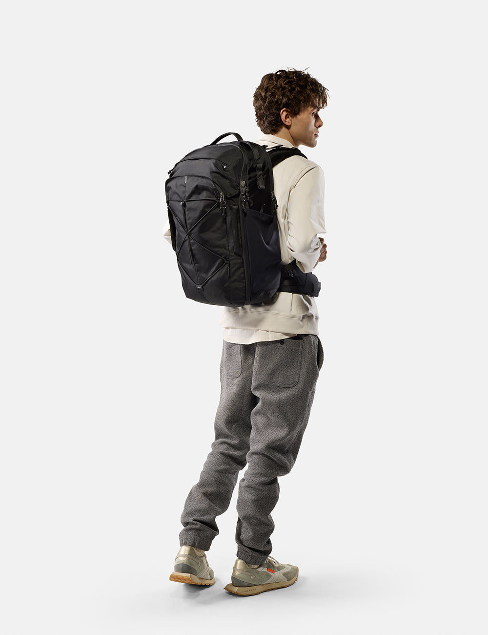 Matador 35L Global Travel Pack in Black - person wearing a black backpack on a white background