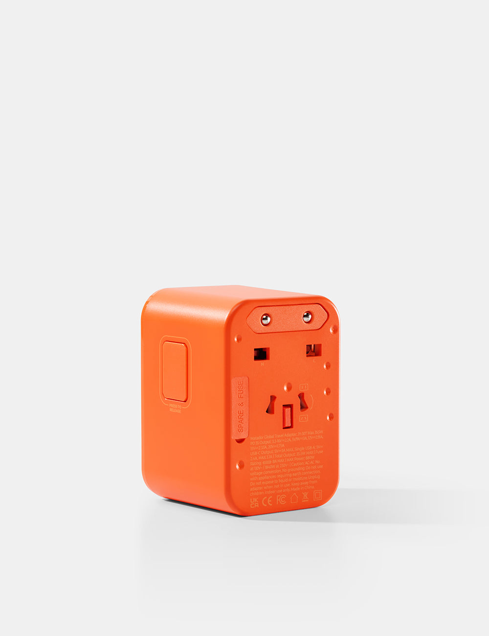 Matador Global Travel Adapter in Orange - orange power adapter on a white background