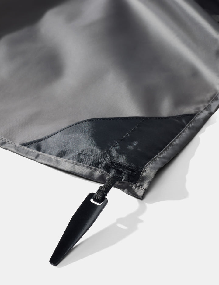 Matador Pocket Blanket™ 4.0 - 160 x 110cm in Ghost Grey - close-up of pocket blanket corner stake on a white background