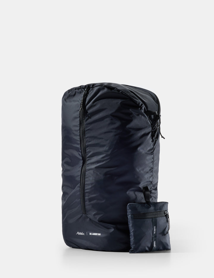 Matador Packable Laundry Bag - black laundry bag with a pocket on a white background