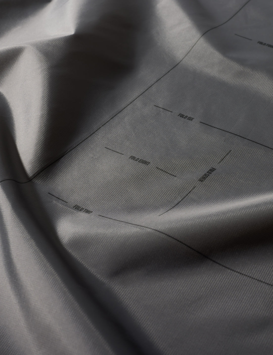 Matador Mini Pocket Blanket™ 4.0 - 110 x 70cm in Ghost Grey - close-up of gray fabric with subtle texture and folds