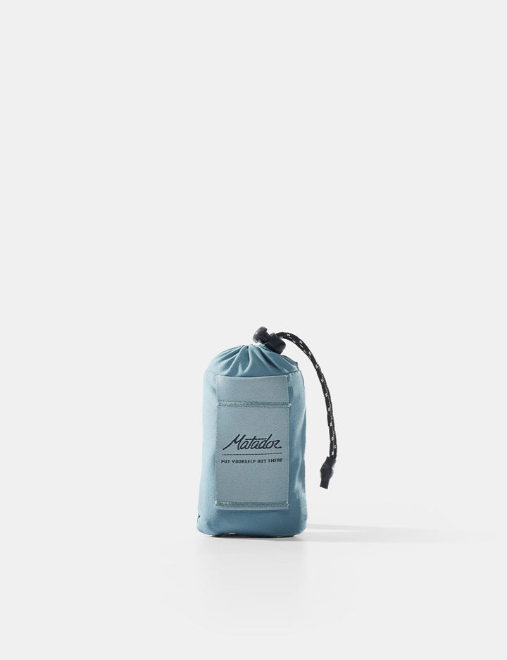 Matador Mini Pocket Blanket™ 4.0 - 110 x 70cm in Blue - blue drawstring pouch with brand logo on a white background