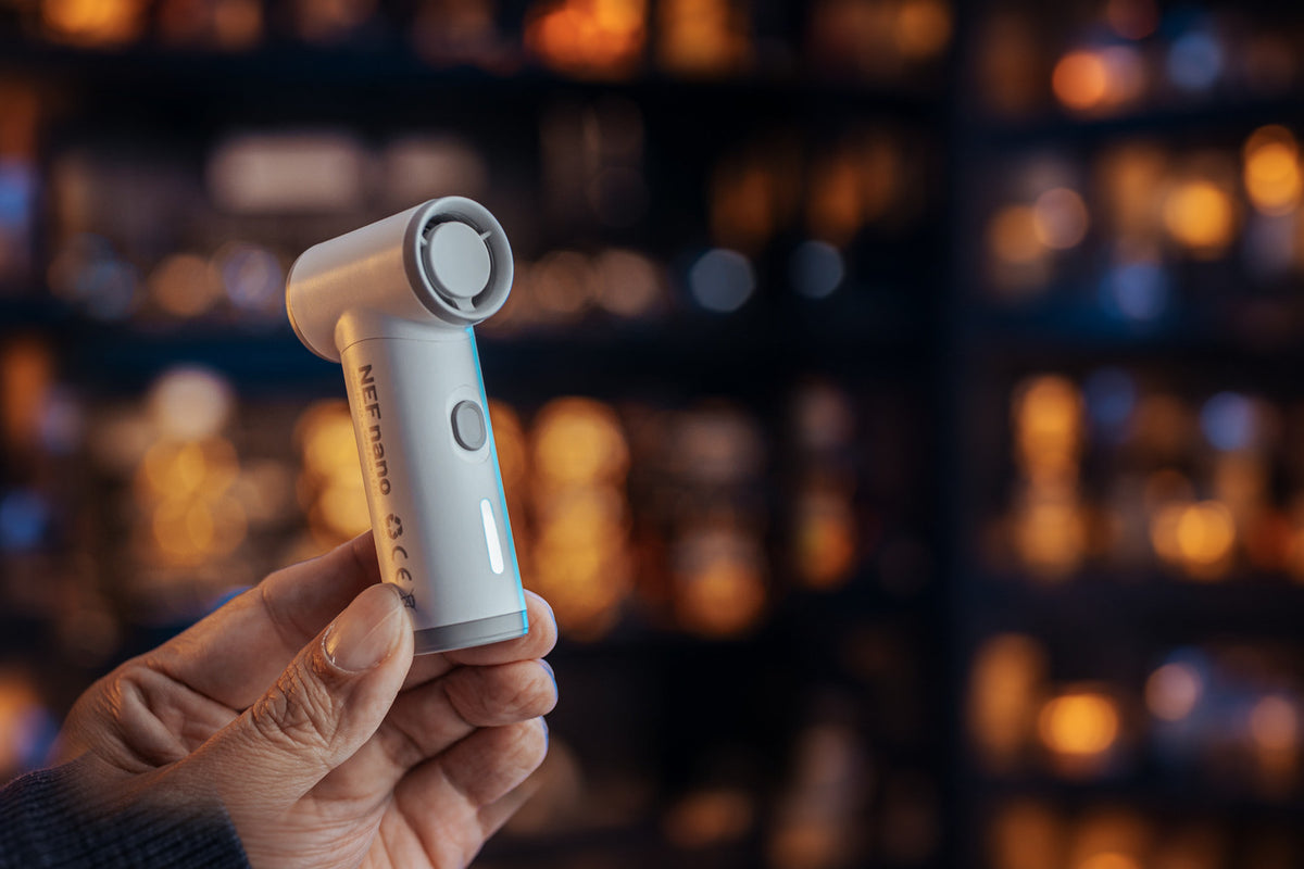 NEF Nano handheld fan held in hand, wide homepage hero