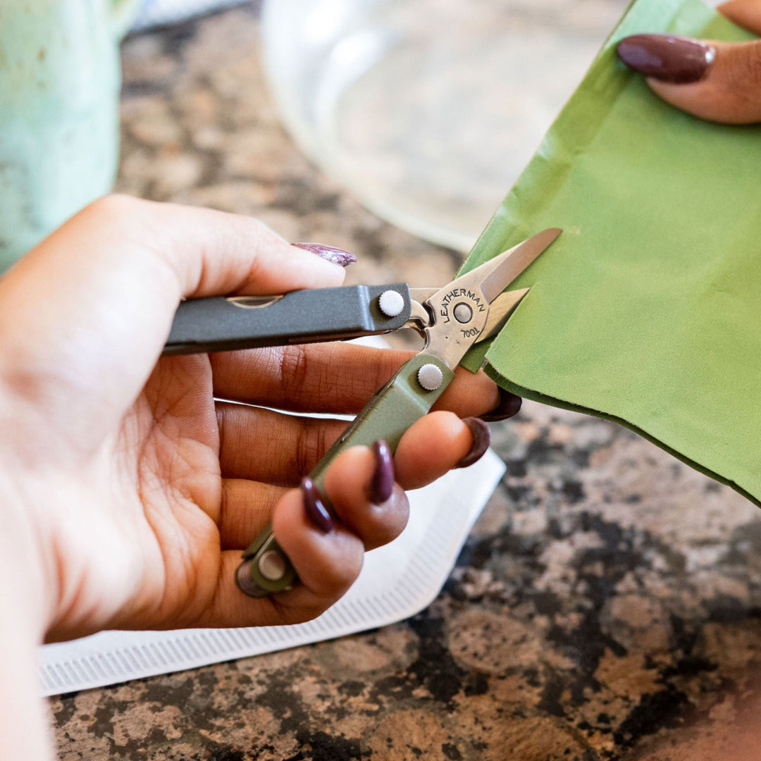 Leatherman Micra - Spruce scissors cutting fabric at a craft table - Nitecore Singapore