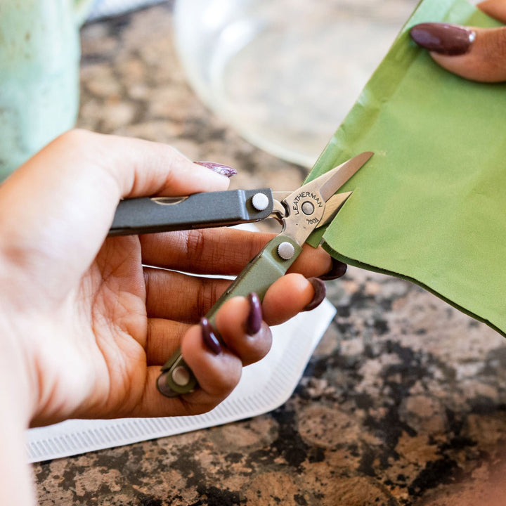 Leatherman Micra - Spruce scissors cutting fabric at a craft table - Nitecore Singapore