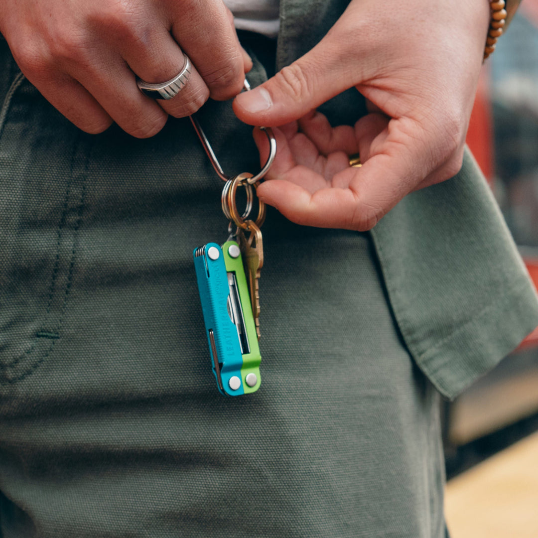 Leatherman Micra - Teal Twist clipped to a carabiner key ring - Nitecore Singapore